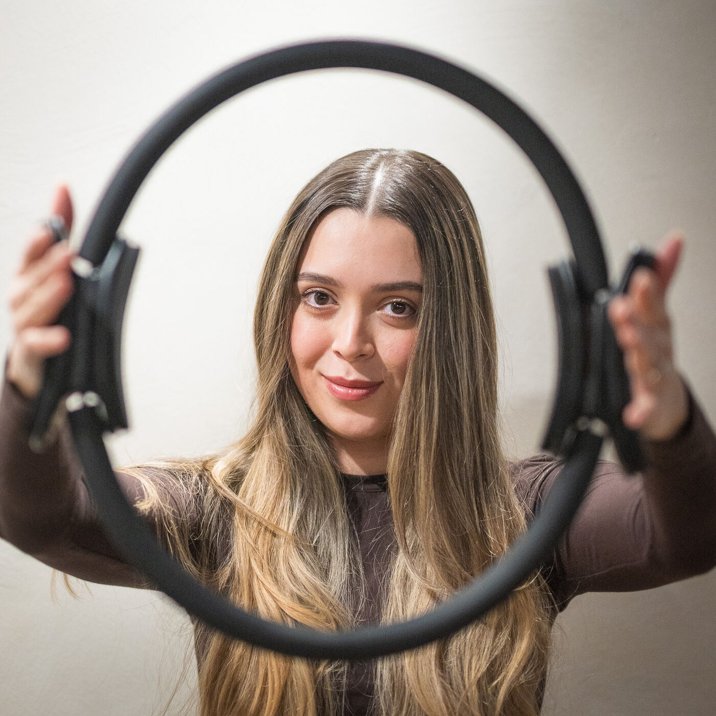 Maria holding a Pilates magic circle